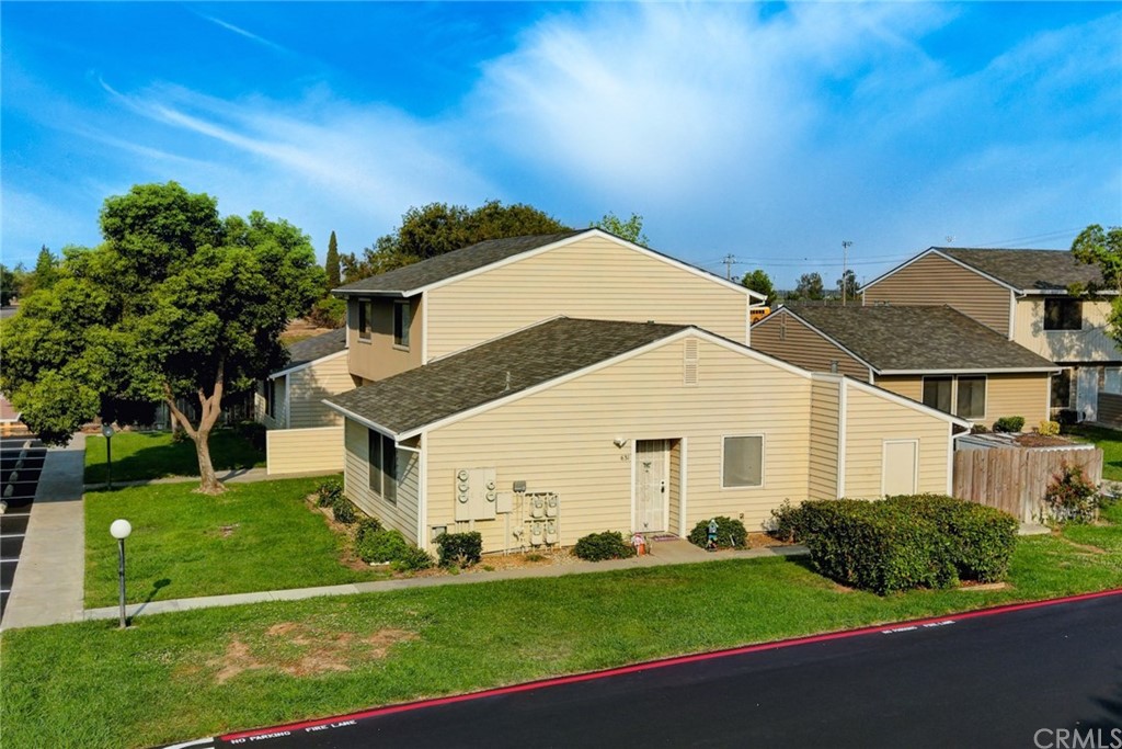 631 North Street Corning, CA 96021 - Photo 4 of 45 a view of a white house next to a yard with big trees