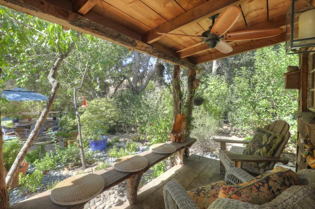a view of a chairs and table in backyard