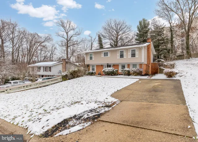 a view of white house with a yard covered in snow