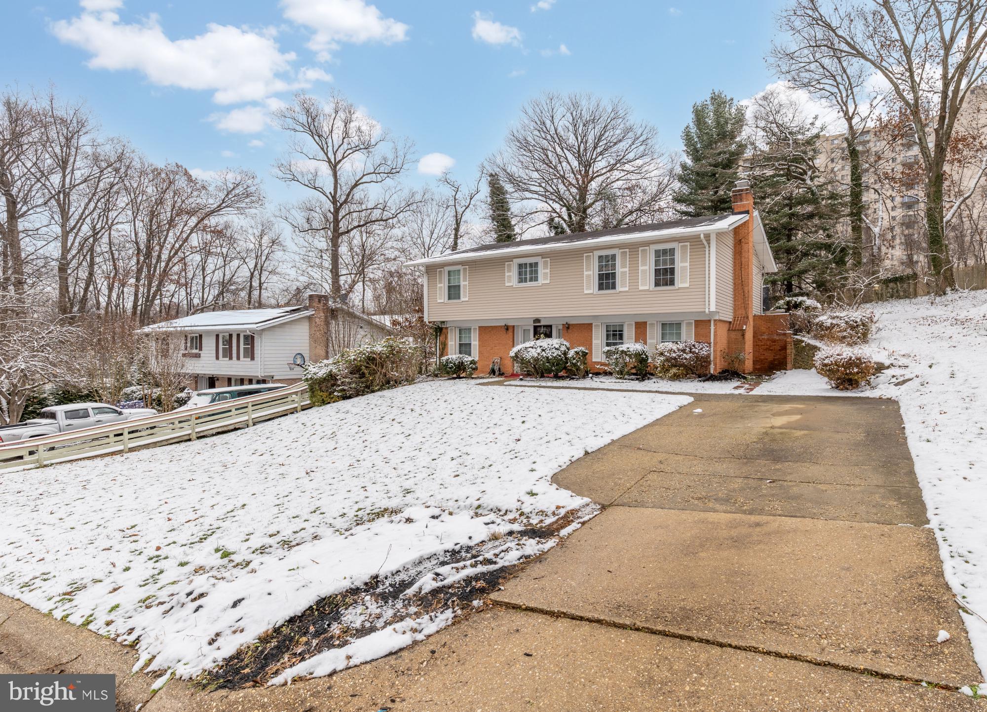 1513 Menlee Drive Silver Spring, MD 20904 - Photo 11 of 19 a view of white house with a yard covered in snow