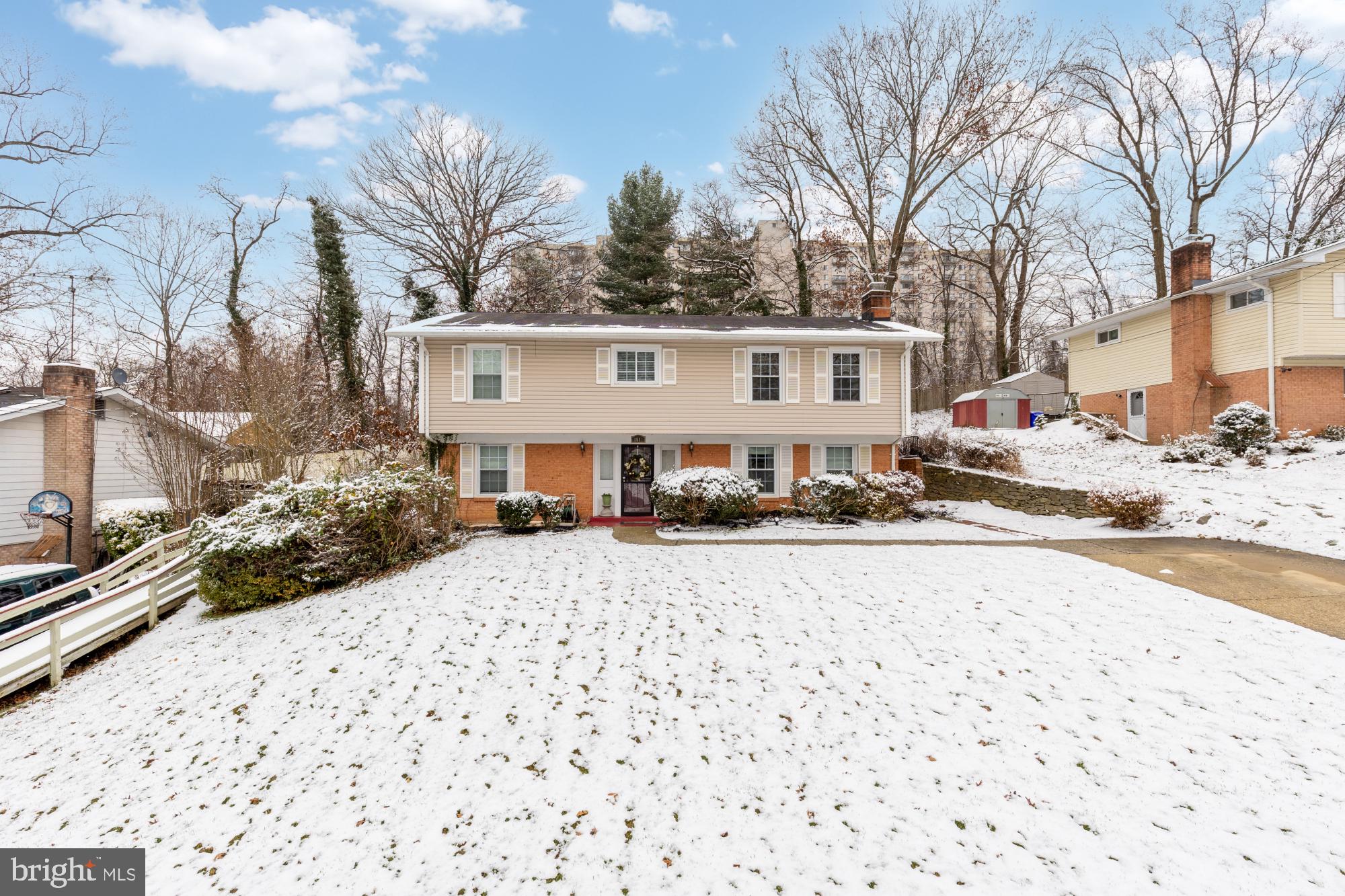 1513 Menlee Drive Silver Spring, MD 20904 - Photo 12 of 19 a front view of a house with a yard covered in snow