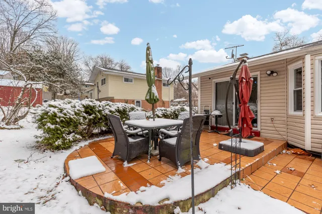 a view of a patio with table and chairs