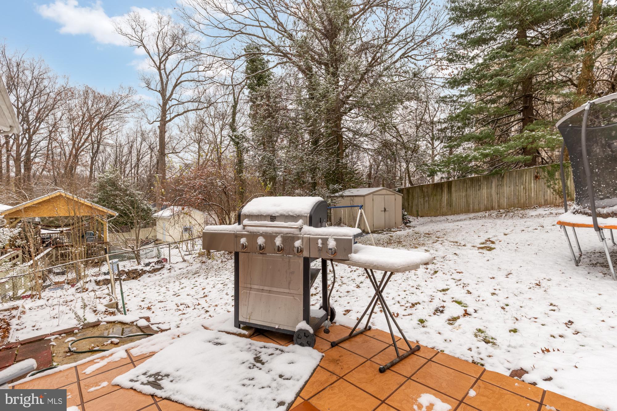 1513 Menlee Drive Silver Spring, MD 20904 - Photo 15 of 19 a view of a backyard with table and chairs under an umbrella