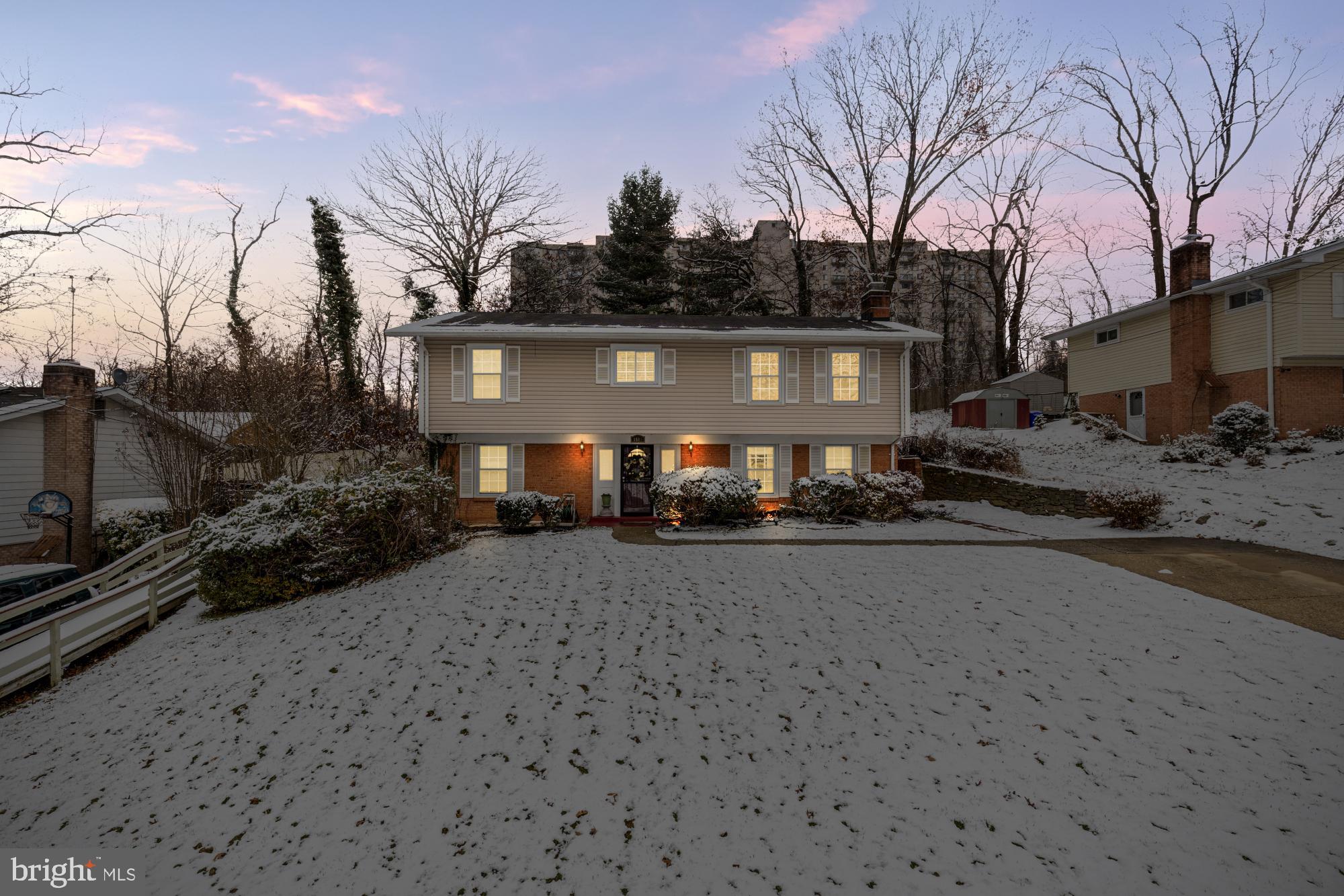 1513 Menlee Drive Silver Spring, MD 20904 - Photo 19 of 19 a front view of a house with yard and trees in the background