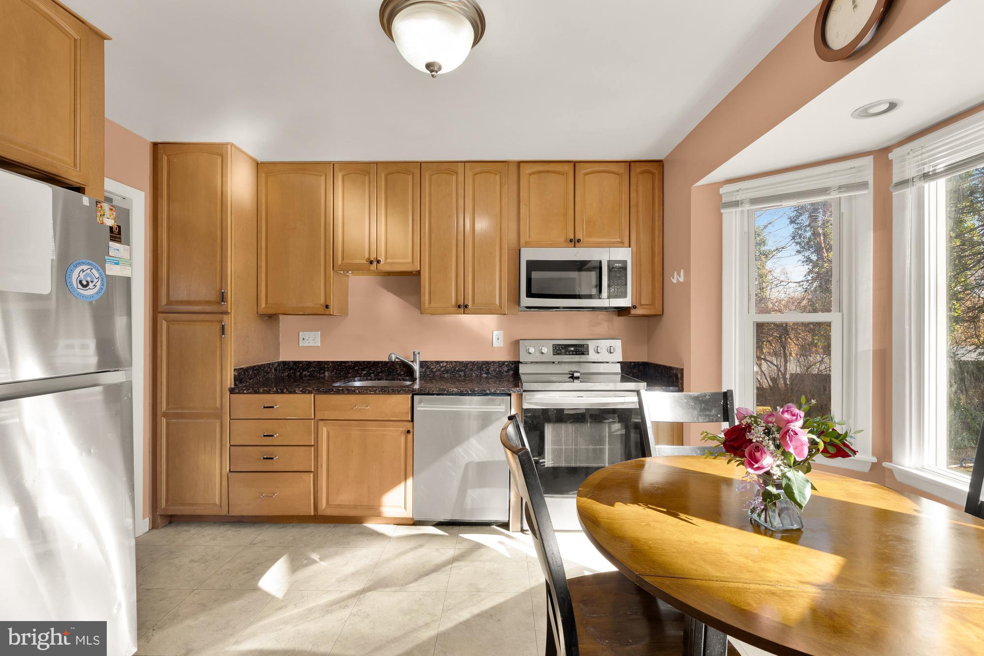 1513 Menlee Drive Silver Spring, MD 20904 - Photo 4 of 19 a kitchen with a refrigerator a stove a sink dishwasher with a dining table and chairs