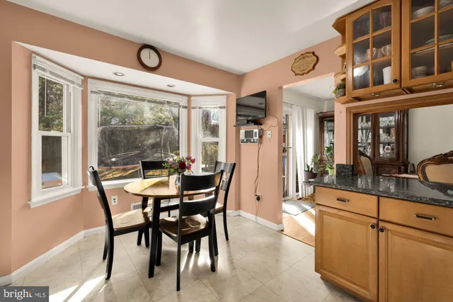 a dining room with furniture and large windows
