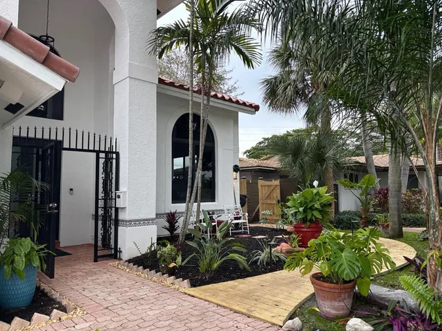 a potted plant sitting in front of a house