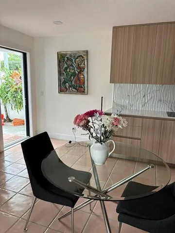 a view of a dining room with furniture and a potted plant