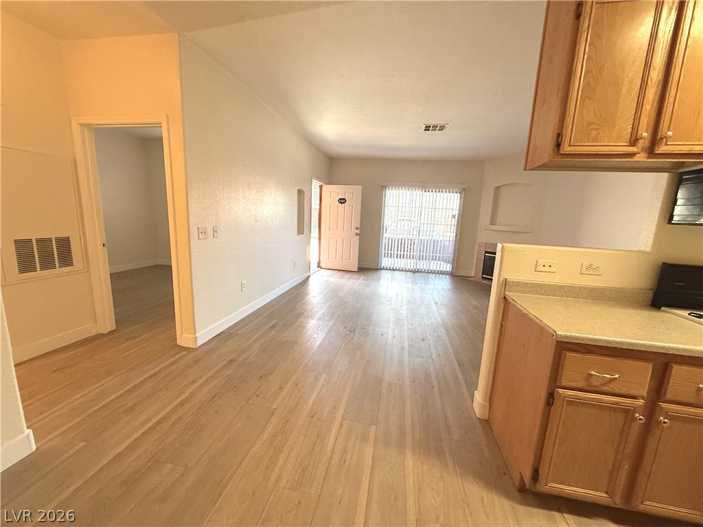 4730 East Craig Road, Unit 1164 Las Vegas, NV 89115 - Photo 5 of 14 Blonde wood flooring creates a welcoming flow from the open-concept kitchen into the living area.