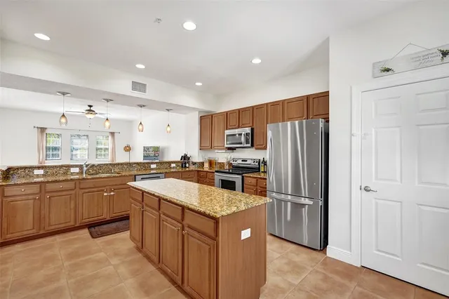 a kitchen with granite countertop stainless steel appliances and sink