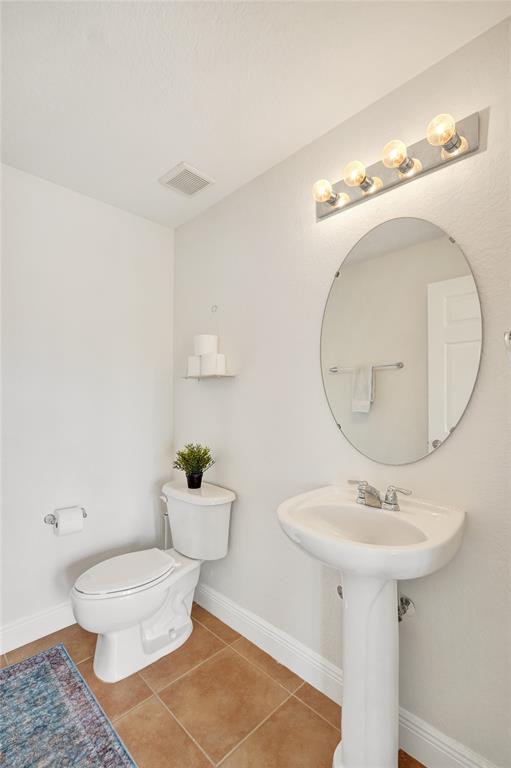 228 Southwest 6th Court Pompano Beach, FL 33060 - Photo 22 of 50 a bathroom with a sink a mirror and a toilet