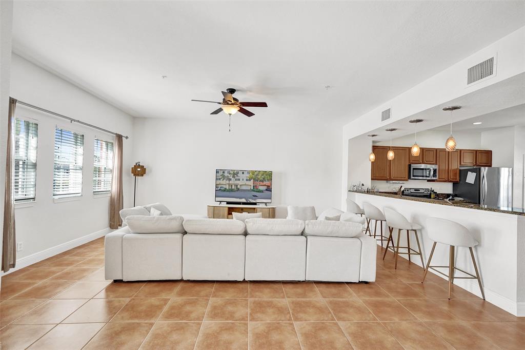 228 Southwest 6th Court Pompano Beach, FL 33060 - Photo 23 of 50 a living room with furniture and a flat screen tv