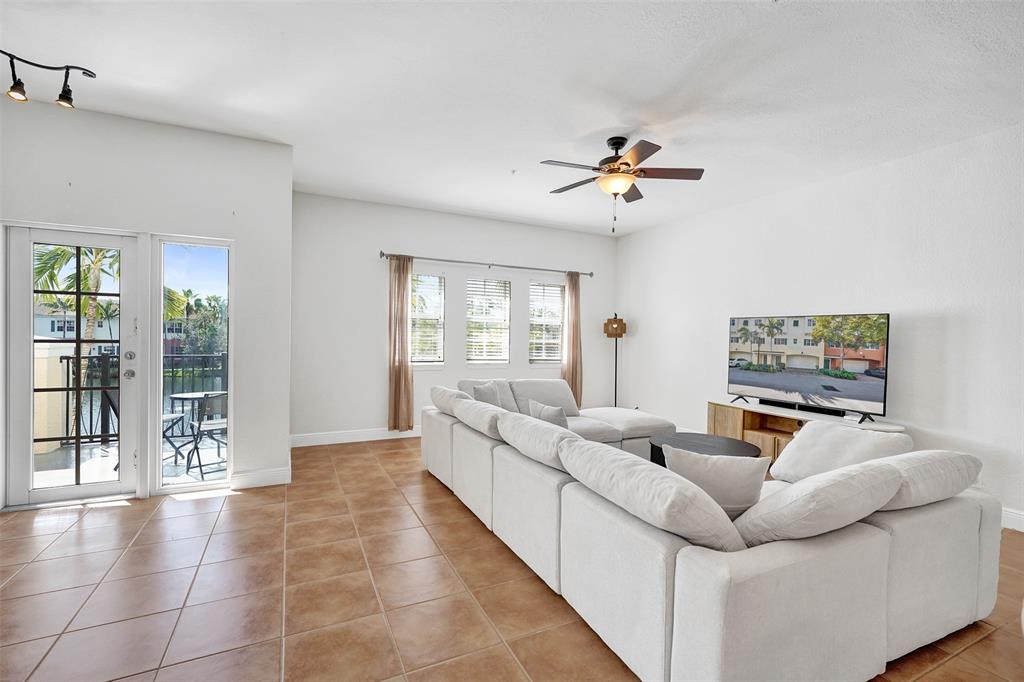 228 Southwest 6th Court Pompano Beach, FL 33060 - Photo 25 of 50 a living room with furniture and a flat screen tv