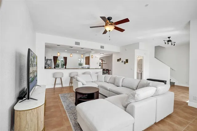 a living room with furniture white walls and a flat screen tv
