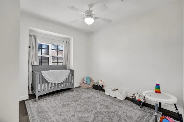 a living room with baby crib furniture and a window