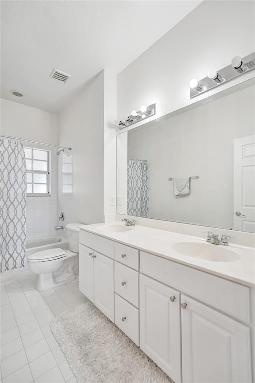 228 Southwest 6th Court Pompano Beach, FL 33060 - Photo 35 of 50 a spacious bathroom with a double vanity sink toilet mirror and bathtub