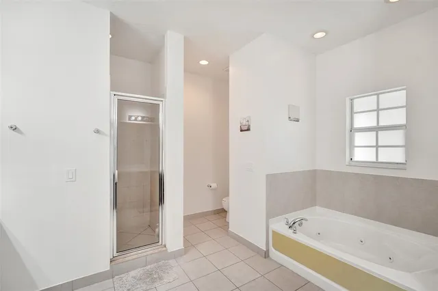 a bathroom with a bathtub and a shower