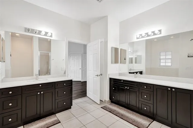 a spacious bathroom with double vanity sink double and mirror
