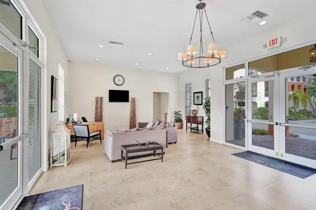 a living room with furniture and a chandelier