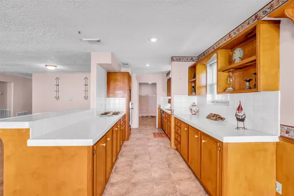 a kitchen with stainless steel appliances granite countertop a sink and dishwasher next to a window