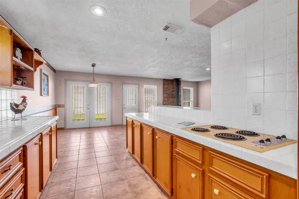 a large kitchen with stainless steel appliances a sink and cabinets