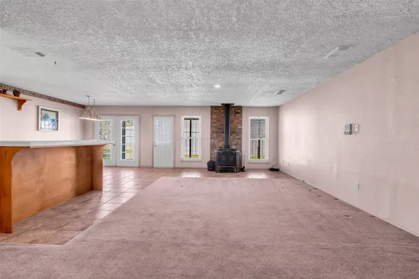 a view of a big room with windows and chandelier