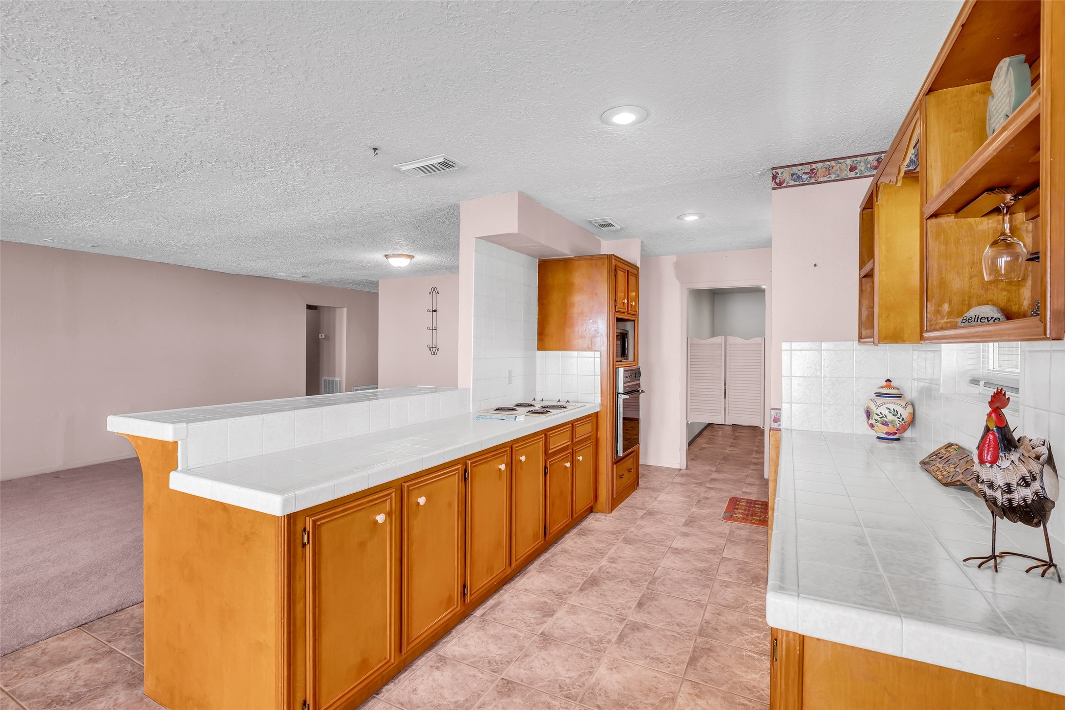 32134 Robin Lane Waller, TX 77484 - Photo 7 of 25 a large kitchen with stainless steel appliances a large counter top a stove a chimney a sink and a refrigerator