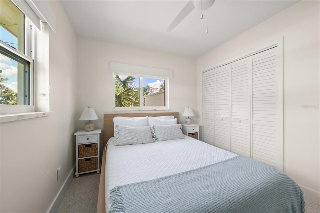127 11th Avenue Indian Rocks Beach, FL 33785 - Photo 17 of 63 a bedroom with a bed and a window