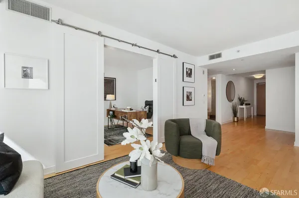 a living room with furniture and a wooden floor