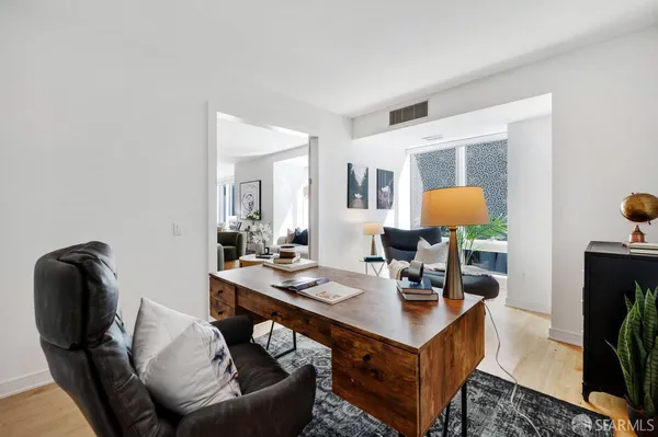 a living room with furniture and wooden floor