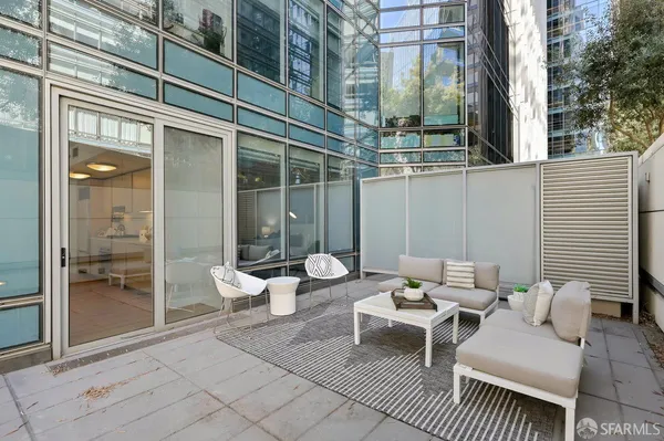 a view of a patio with couches and potted plants