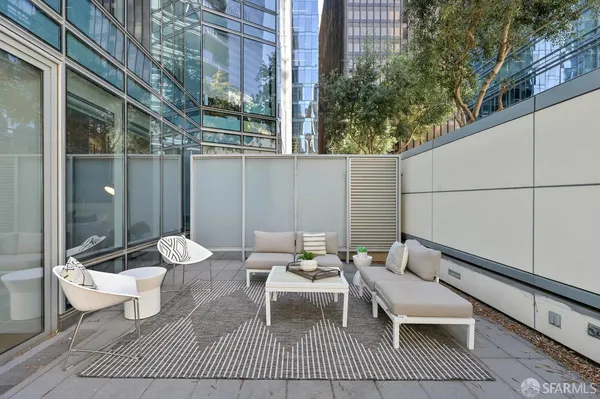 a view of a patio with couple of chairs and a table