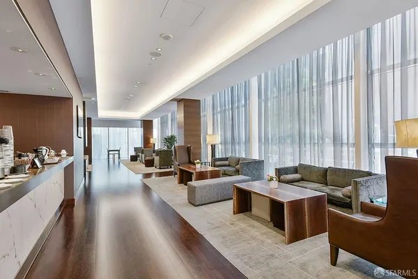 a living room with furniture and large windows