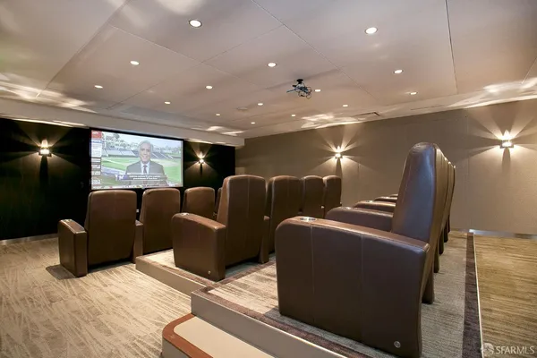 a media room with lots of chairs and a projector screen