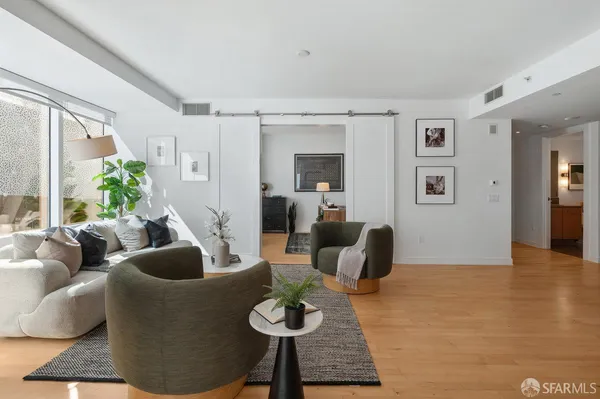 a living room with furniture and wooden floor