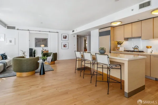 a living room with furniture a window and kitchen view