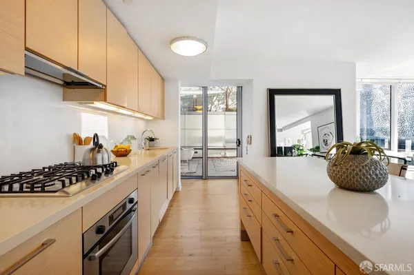 a kitchen with stainless steel appliances a sink a stove and a window