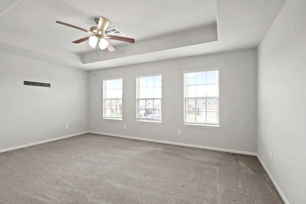 a view of an empty room and a ceiling fan