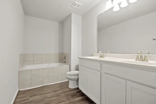 a bathroom with a double vanity sink and mirror