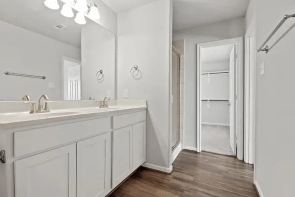 a bathroom with a sink a toilet a shower and a mirror