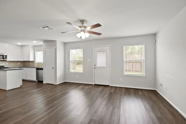 wooden floor in an empty room with a window