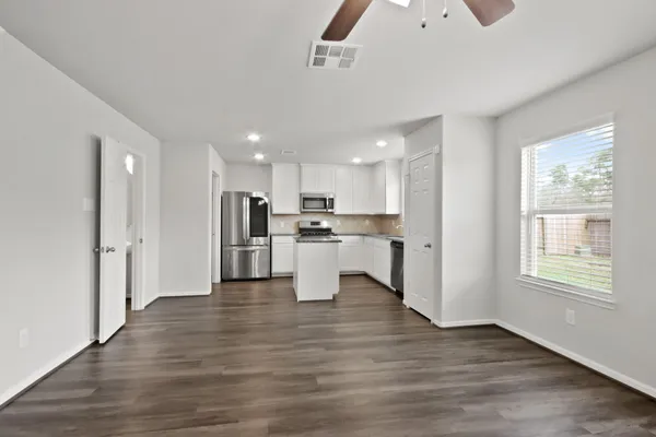 a kitchen with stainless steel appliances granite countertop a refrigerator a stove a sink and a microwave