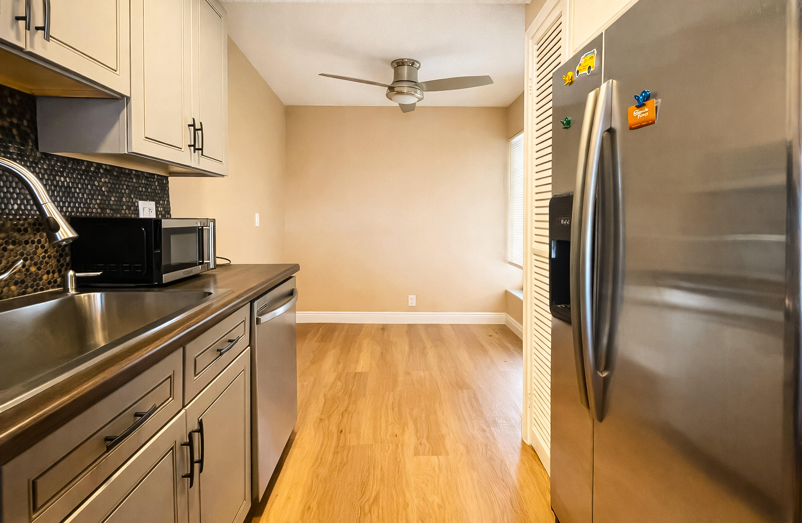 6 Royal Palm Way, Unit 310 Boca Raton, FL 33432 - Photo 11 of 37 a view of a kitchen with a sink cabinets and outdoor space