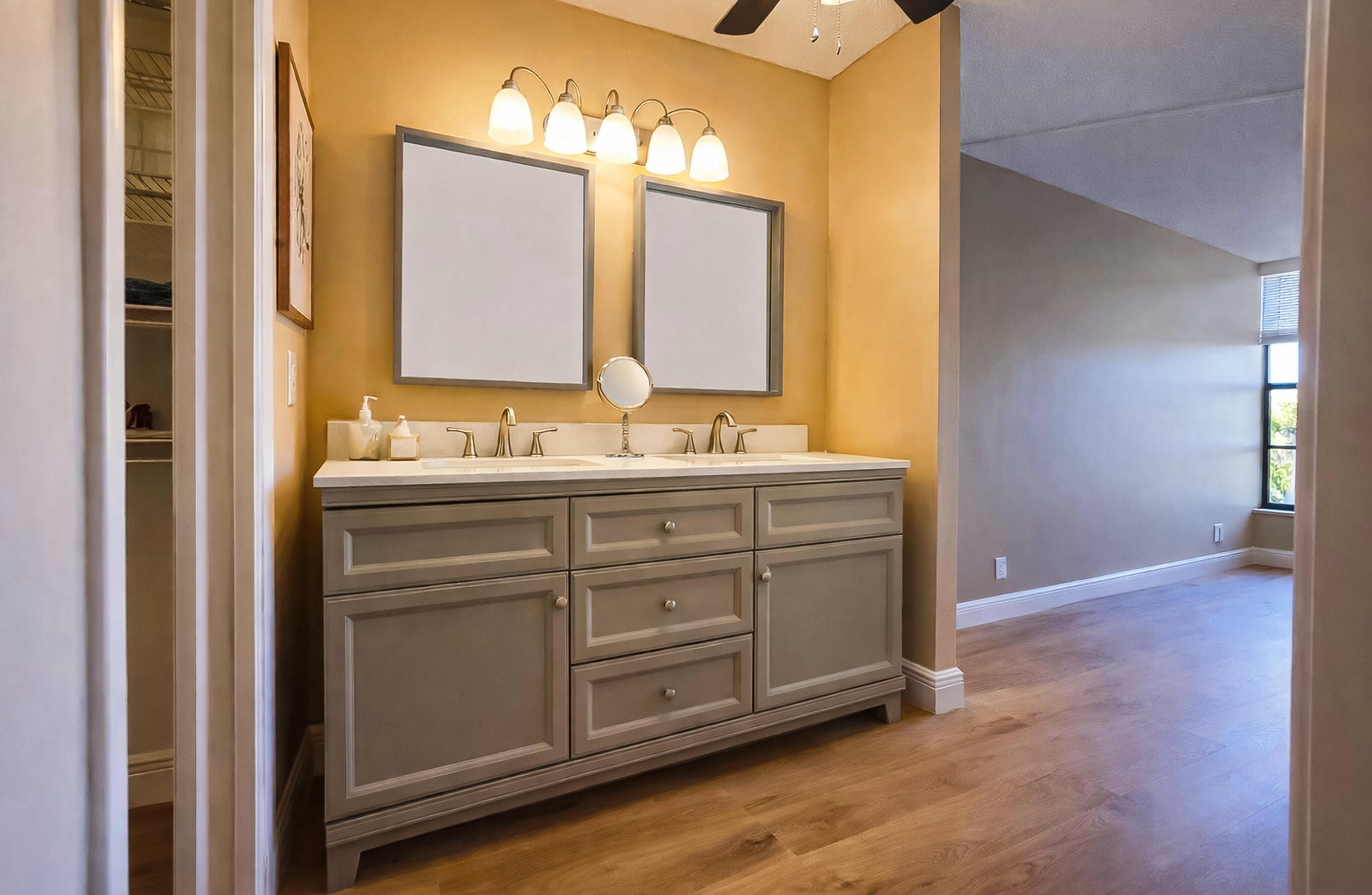 6 Royal Palm Way, Unit 310 Boca Raton, FL 33432 - Photo 13 of 37 a bathroom with a double vanity sink and a mirror