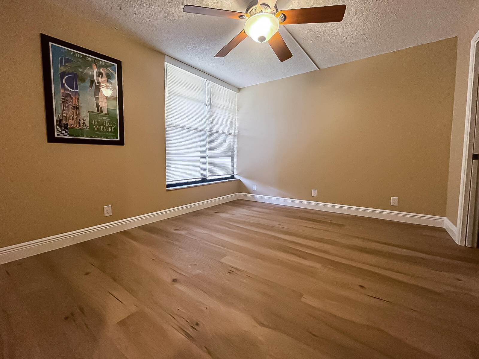 6 Royal Palm Way, Unit 310 Boca Raton, FL 33432 - Photo 17 of 37 a view of an empty room with wooden floor and a window