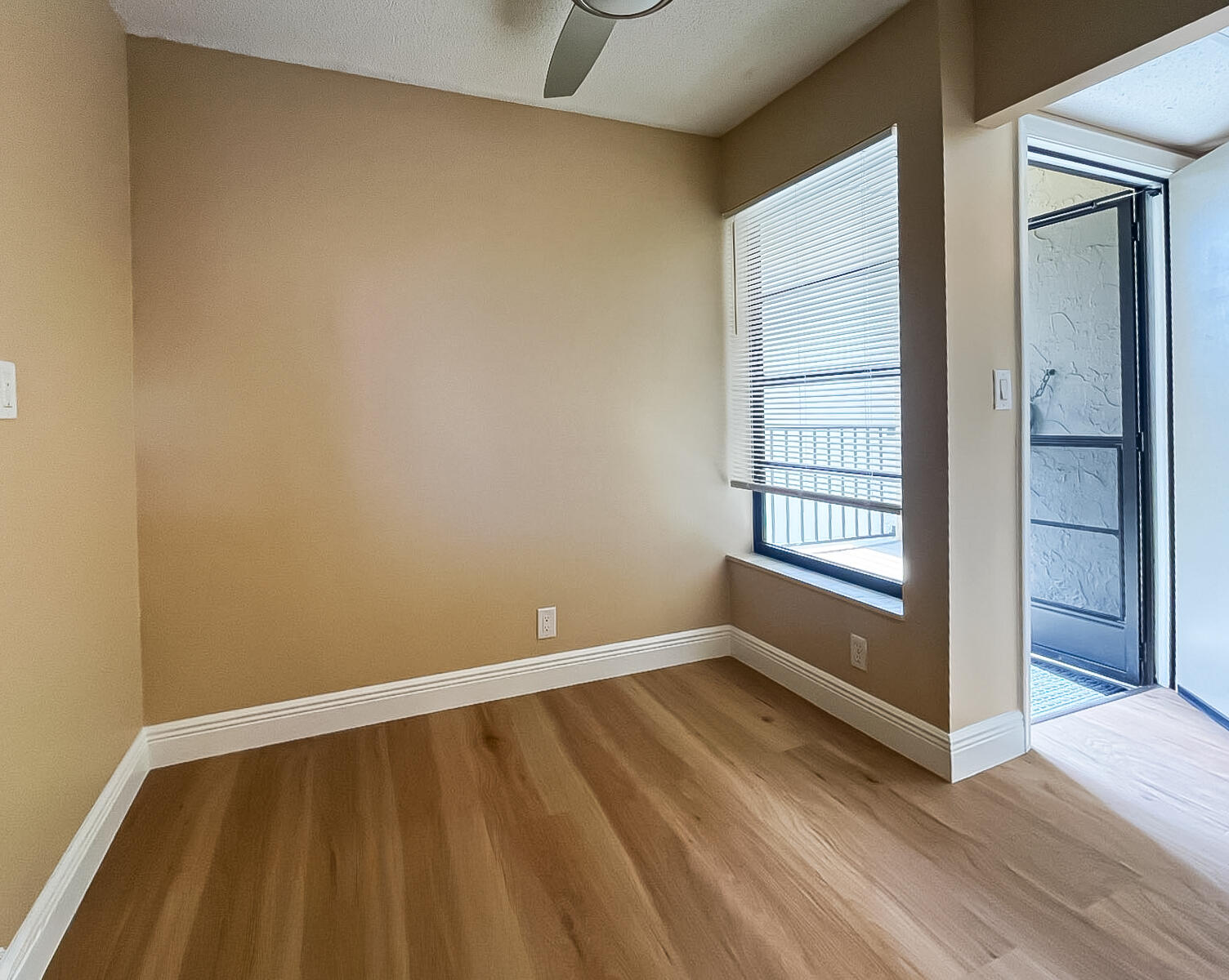 6 Royal Palm Way, Unit 310 Boca Raton, FL 33432 - Photo 8 of 37 a view of an empty room with a window and wooden floor