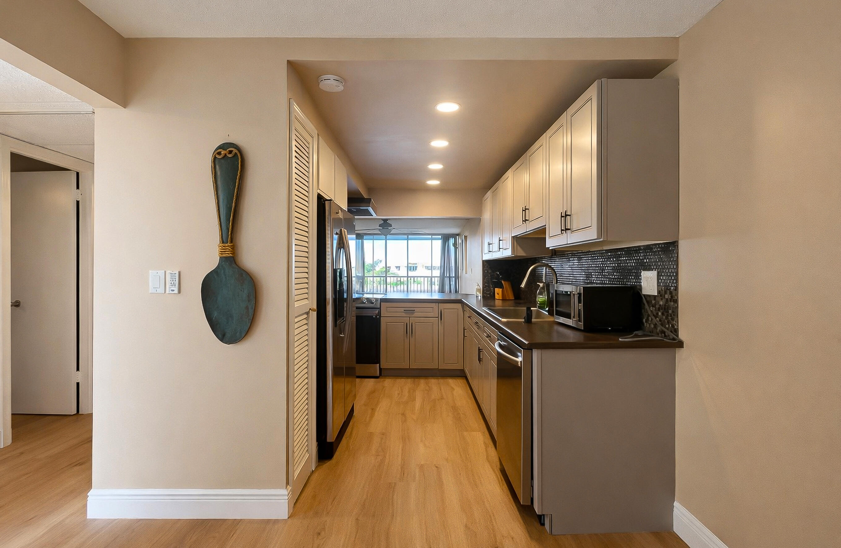 6 Royal Palm Way, Unit 310 Boca Raton, FL 33432 - Photo 10 of 37 a view of a kitchen with a sink and a refrigerator