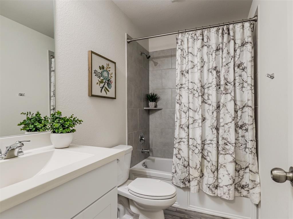 4517 Ashmark Road Aubrey, TX 76227 - Photo 8 of 26 a bathroom with a sink toilet and shower