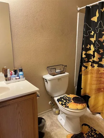 a bathroom with a toilet a sink and a mirror