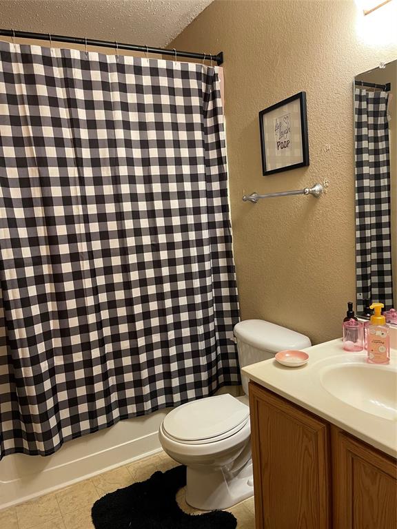 7554 Rice Lane Dallas, TX 75241 - Photo 13 of 16 a bathroom with a sink toilet and shower